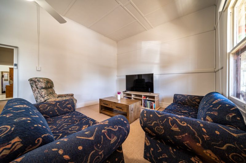 Lounge room features a 60" Smart TV and plenty of comfortable seating