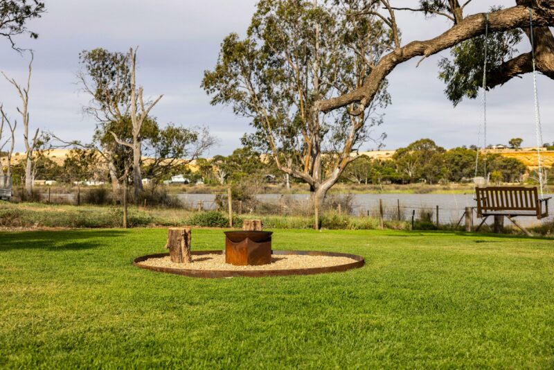 A fire pit and tree swing overlooking the walker flat lagoon