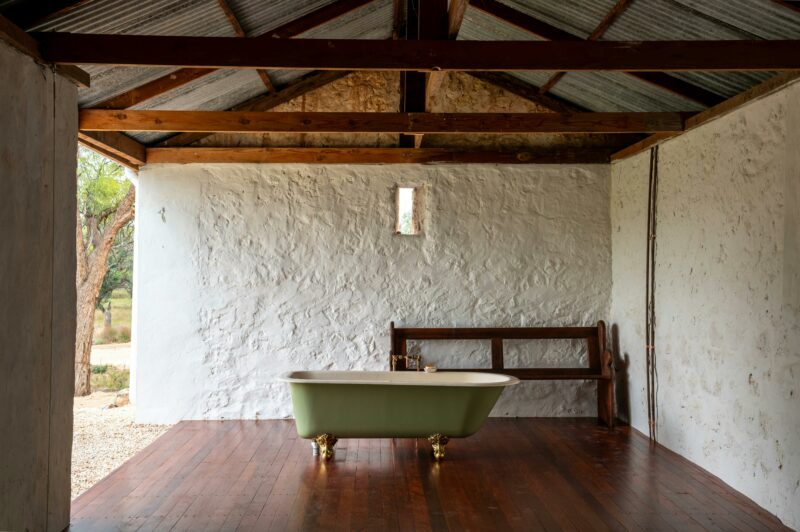 Parcoola Retreats outdoor claw foot bathtub housed inside a historic Fisherman's Cottage
