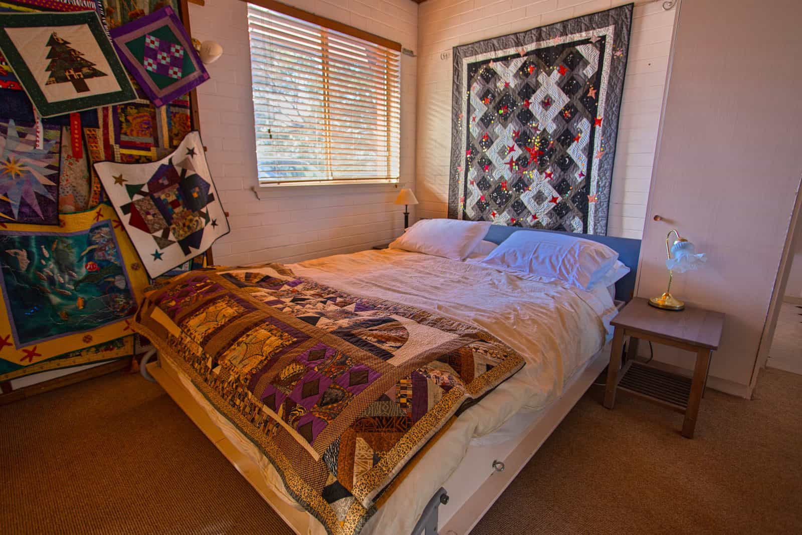 queen sized double bed with quilt bedspread