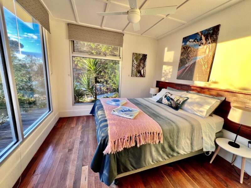 Wake up to expansive sea and bushland views from the master bedroom at Deluxe 2. Enjoy the sunrise