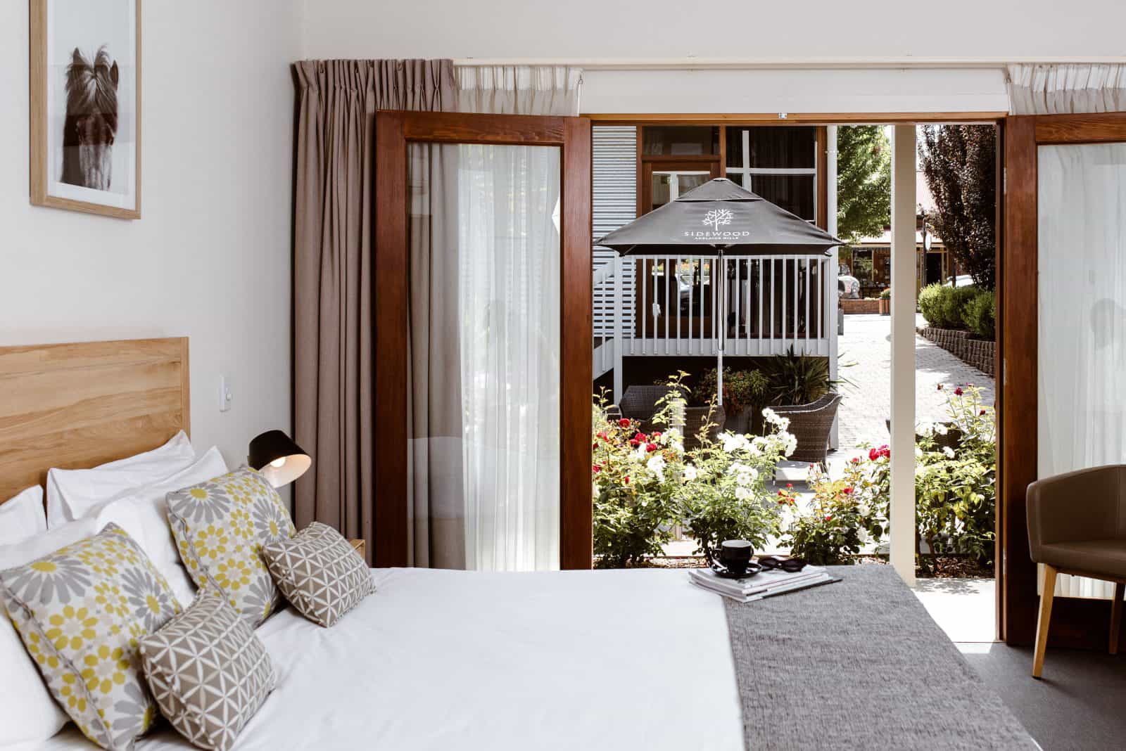 A king-sized bed with Scandinavian-style furnishings, overlooking a garden