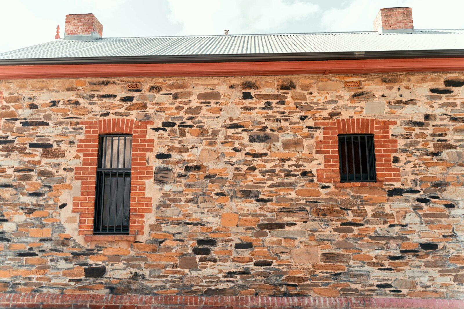 Once a horse stable; the Heritage exterior showcases original crimson brick and masonry stone.
