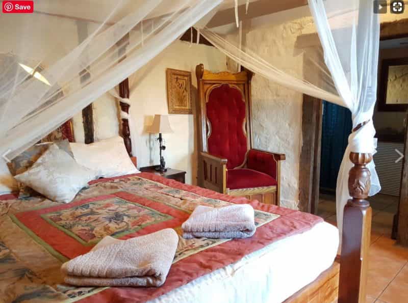 The queen bed in Bronte Manor's Charlotte suite has French doors over valley views and ensuite.