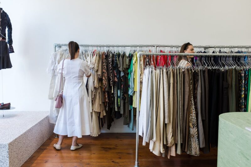 Femme person in a white dress browsing the racks.