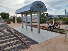 The memorial features storyboards, a telephone 'pill box' and railway lines.