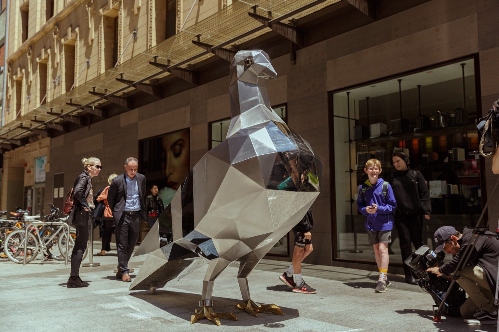A large sculpture of a metal pigeon