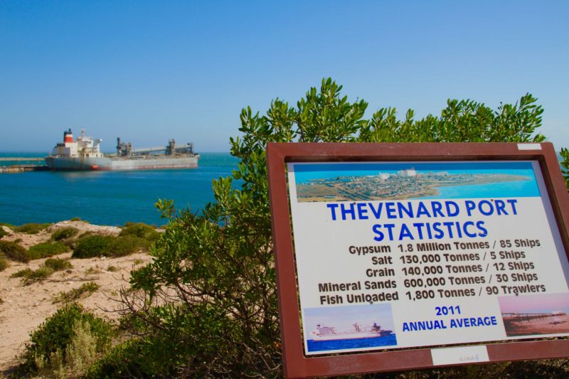 Thevenard Wharf with ship in port viewed from Pinky Point with Port Statistics sign