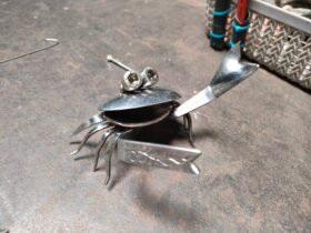 Crabs are made with spoons and forks. Nuts as eyes came from a recycled solar panel.