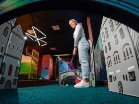 A golfer lining up for a putt on a mini golf course