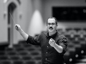 A conductor giving a gesture to an orchestra