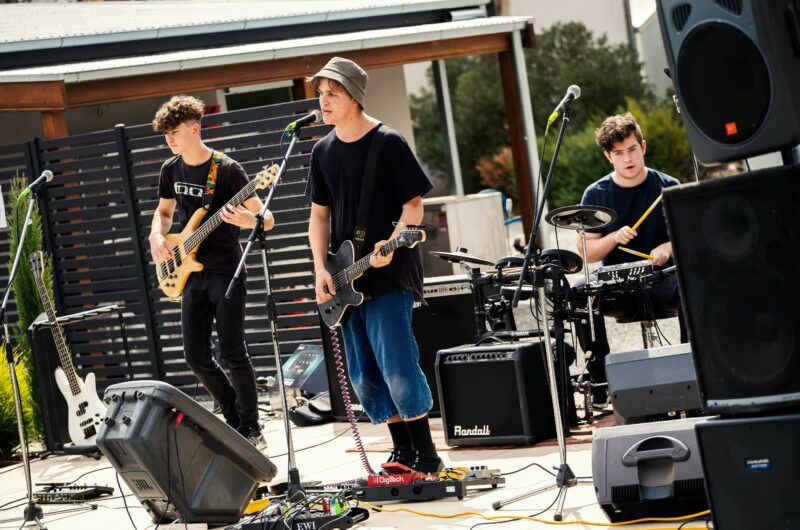 Three young musicans playing on stage