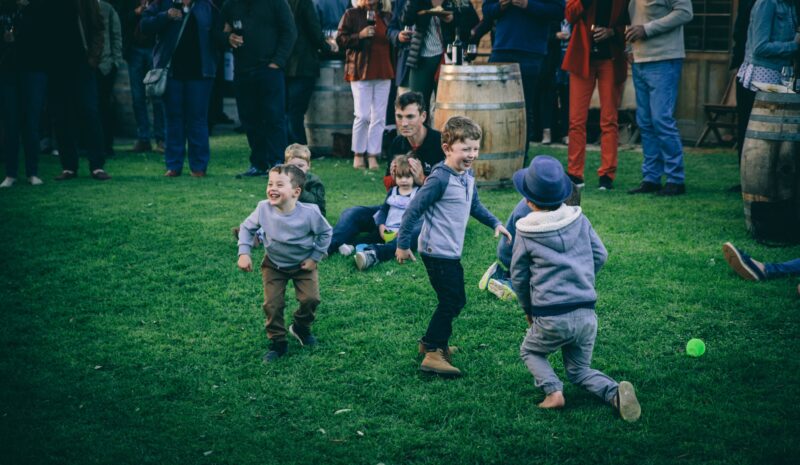 Kids dancing to music on the grass at cellar door