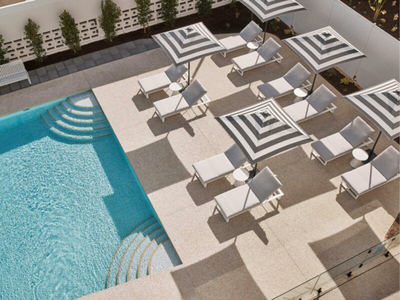 Outdoor swimming pool with sun lounges and umbrellas