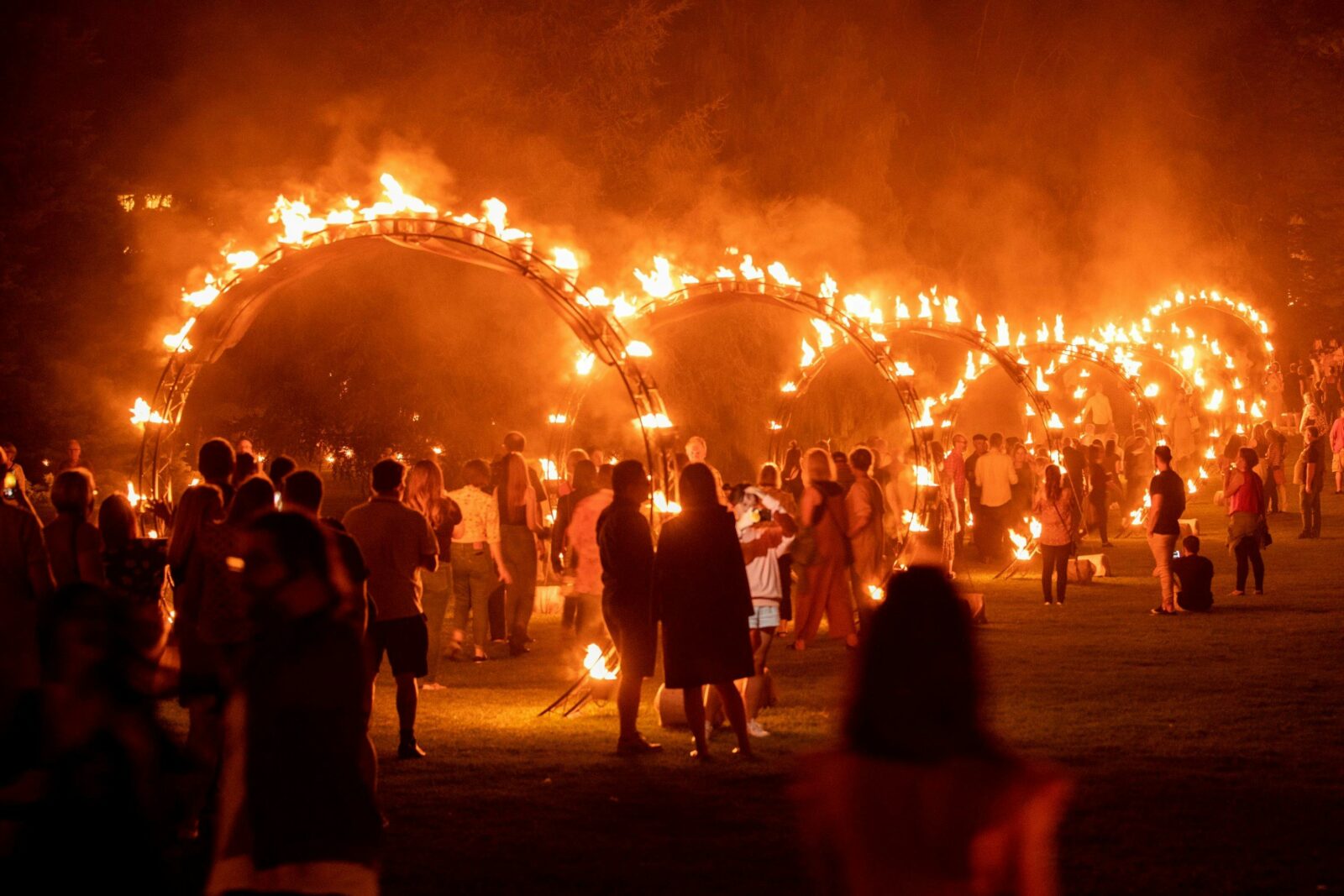 People walking through hoops of fire.