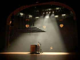 Joep Playing piano on stage in a beautiful theatre.