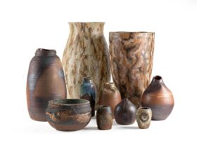 An array of brown looking wheel thrown pots made out of stoneware