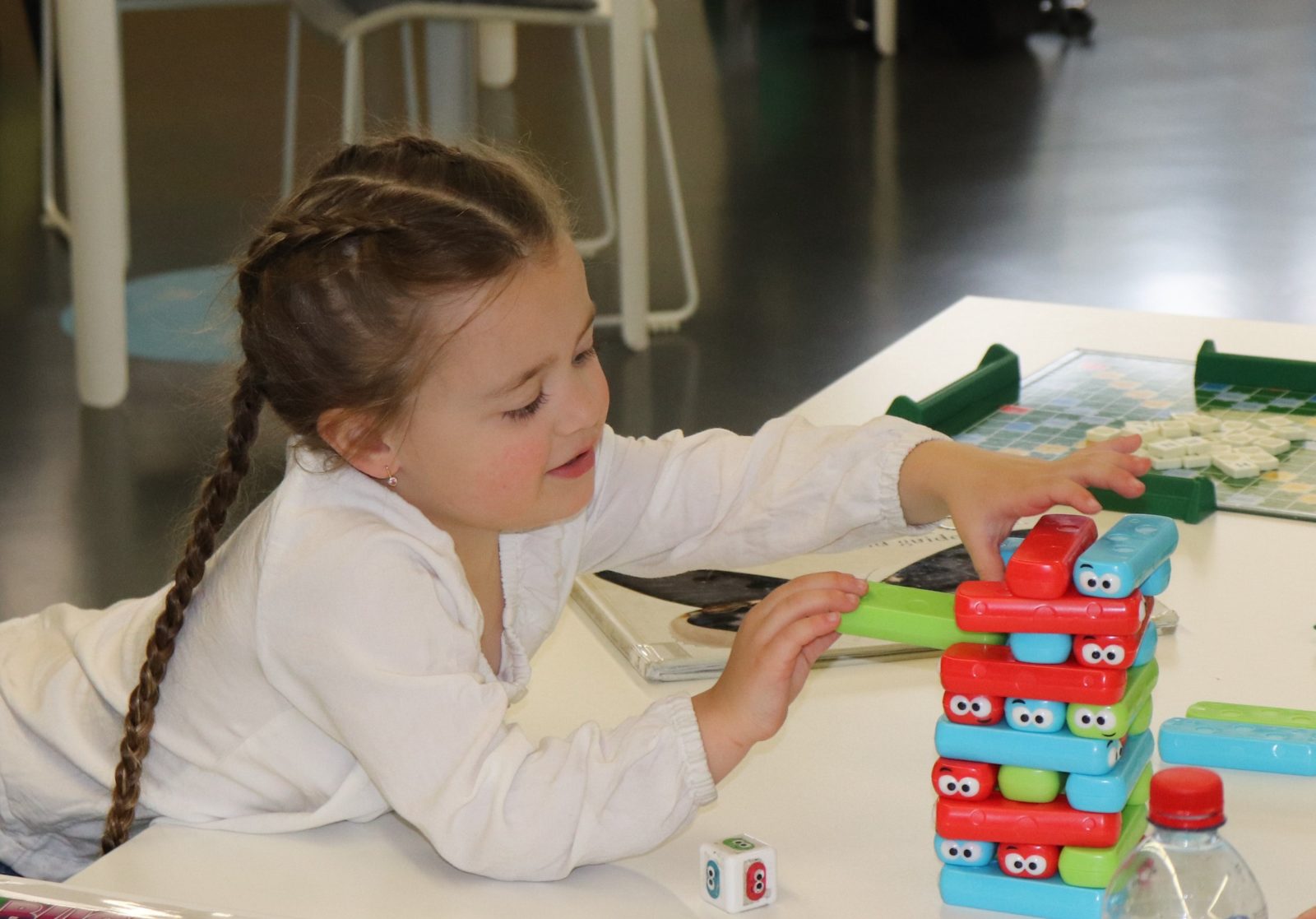 A young girl is playing jenga