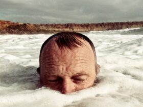 man half submerged in water