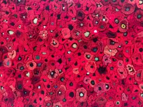 thousands of crocheted red wool flanders poppies