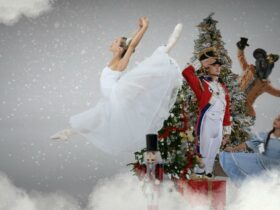 A Ballerina in a white dress, a boy dressed as a nutcracker and a person dresses as a mouse