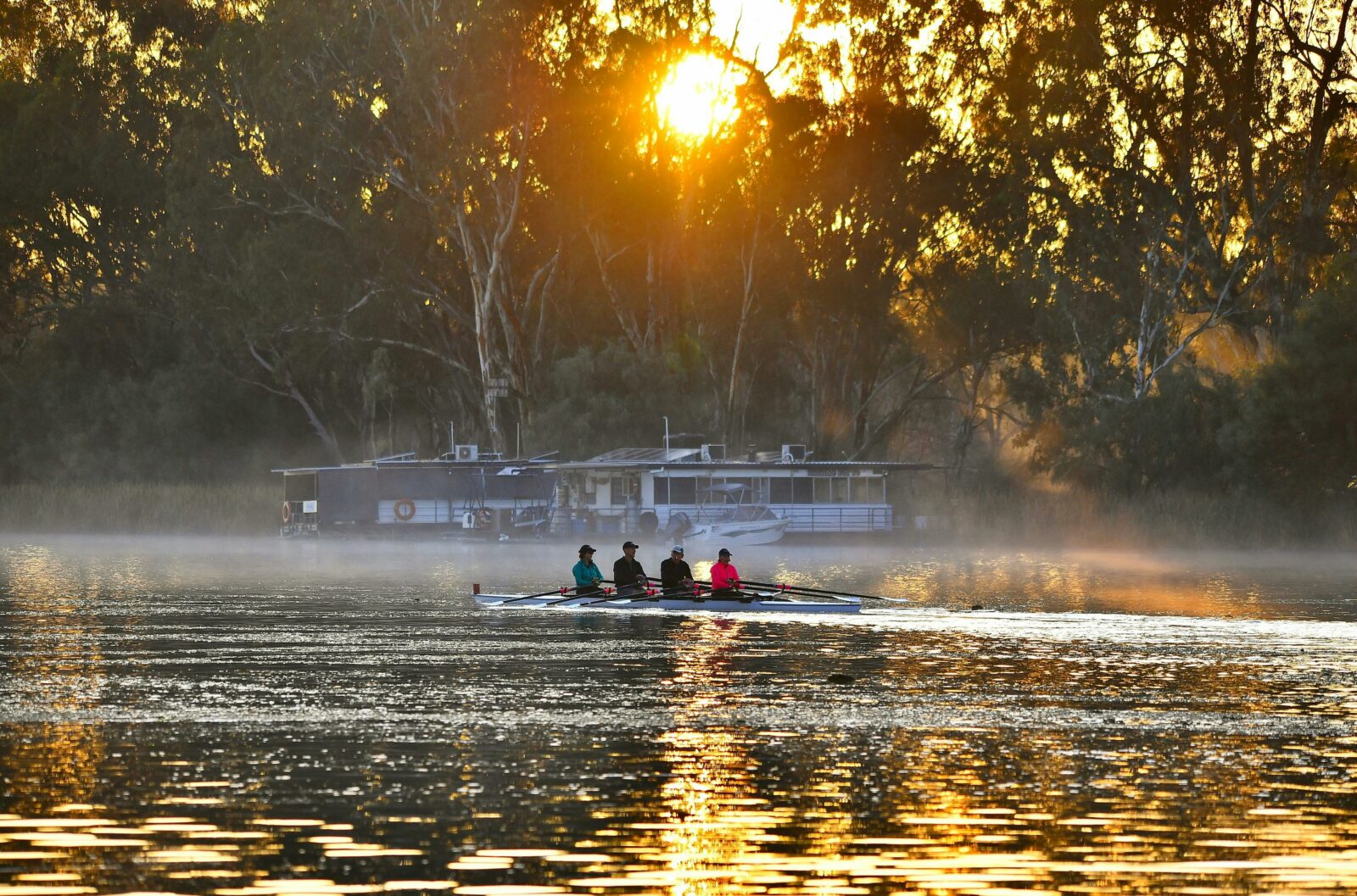 Rowers on sunrise