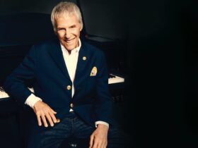Burt Bacharach sit in front of a grand piano