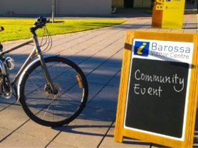 Bicycle next to A-Frame board which reads 'community event'