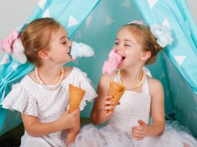 Girls eating fairy floss cones