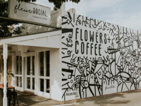 Fleur Social exterior shot including Flowers + Coffee and mural