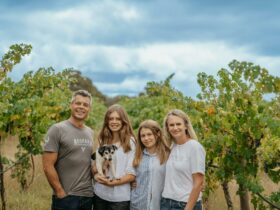 Dru, Nicole and their two girls in vineyards with dog Buster