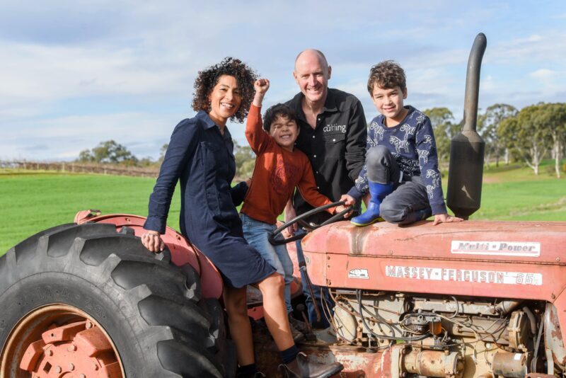 The Cutting family sitting on an old Massey Ferguson tractor still in use today