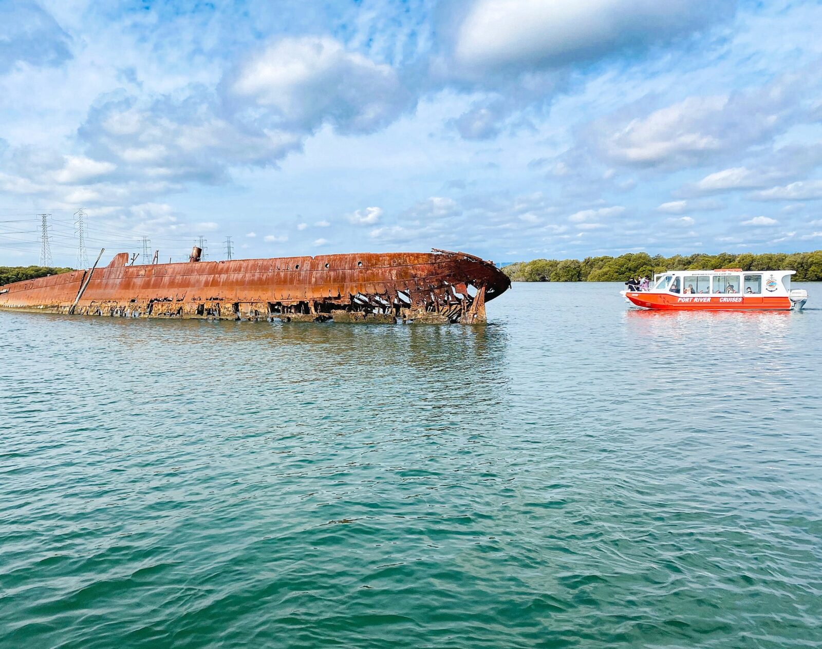 The Port River Cruises vessel approaches a half-sunken ship