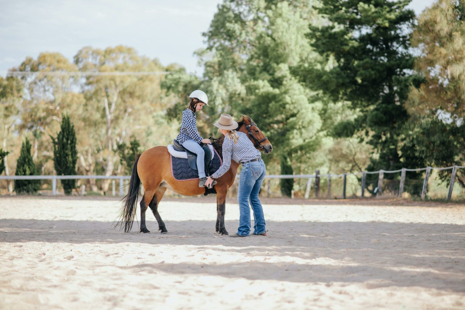 A child and educator undertaking an arena lesson