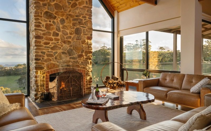 The gorgeous lounge features a local stone open fireplace and cathedral windows with stunning views.