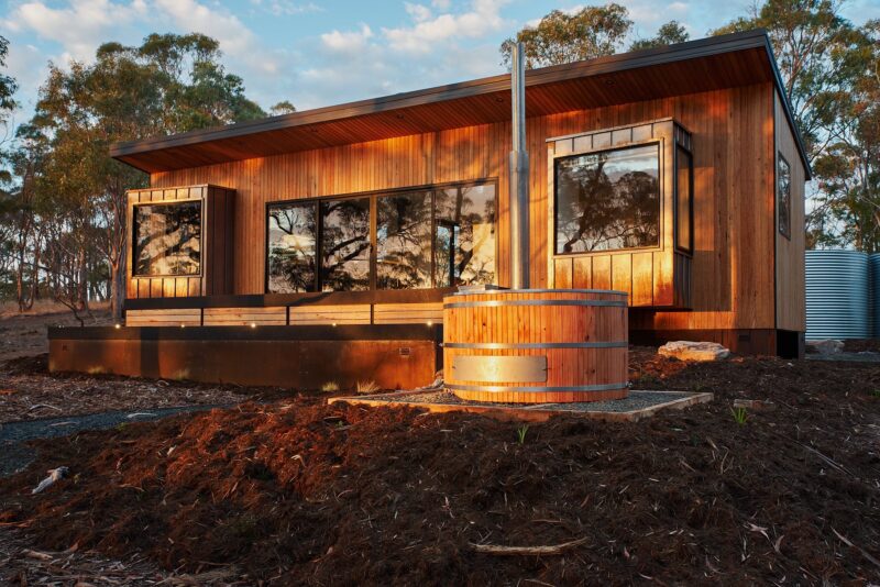 Blue Gum clad exterior cabin in bush setting with woodfired hot tub