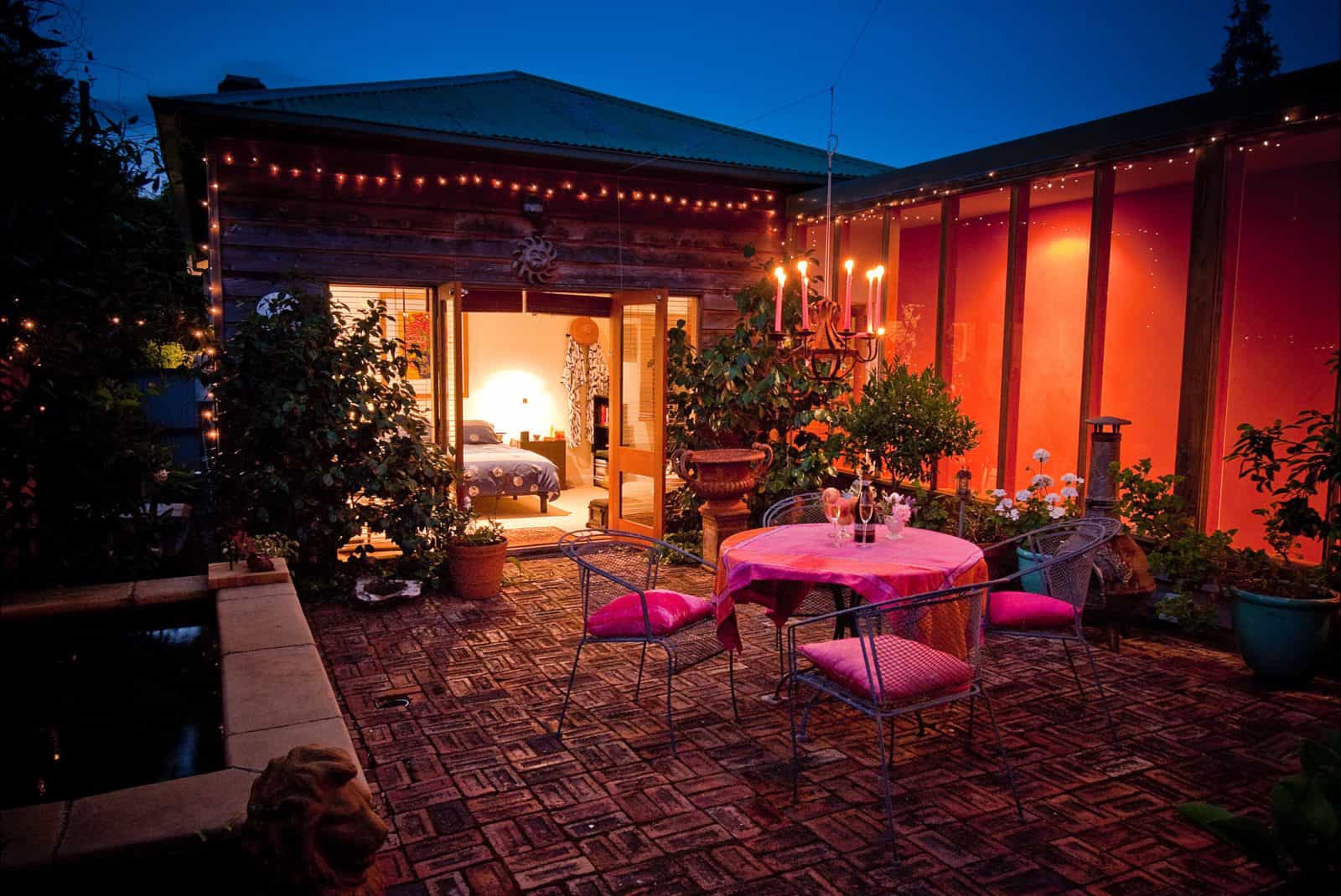Private courtyard with warm glow of the chandelier and tinkling sounds of the fountain