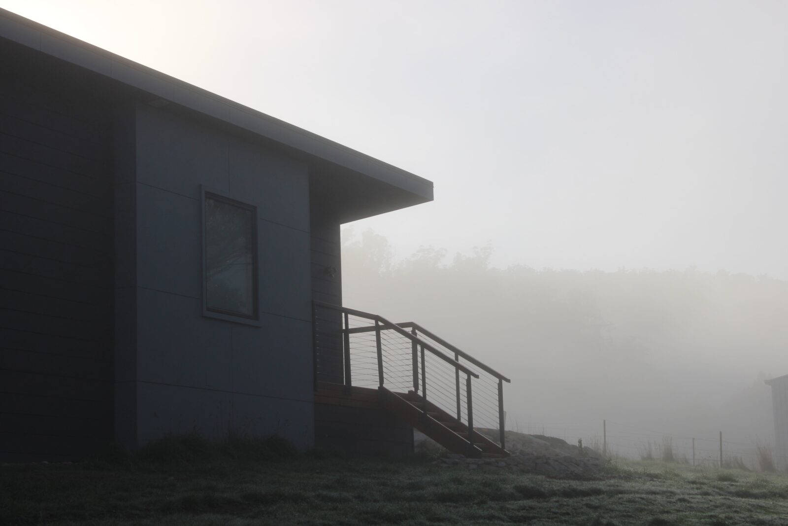 Misty early morning view of house