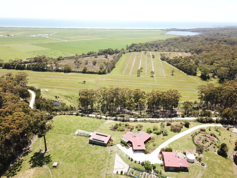 Shows the house and garden and the views beyond including the national park and the ocean.