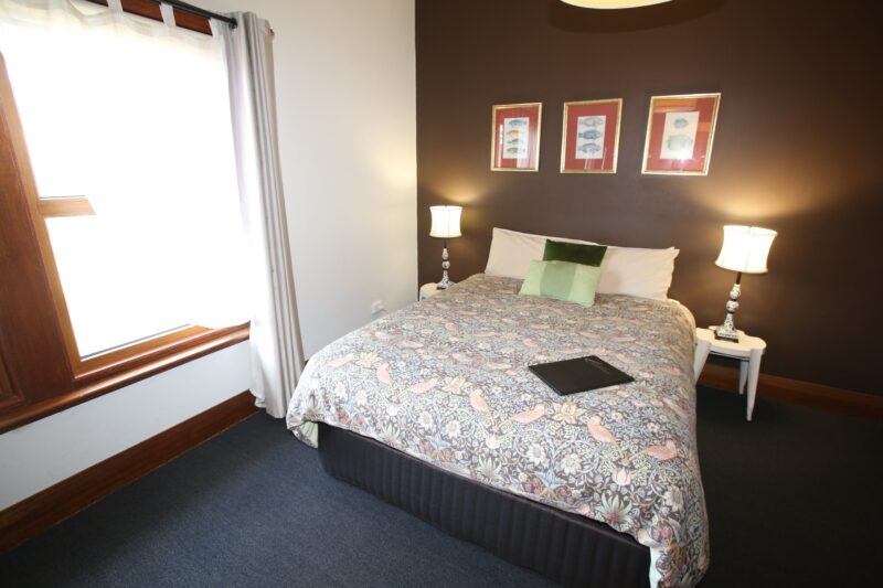Hotel room with Queen Bed and window looking out to Huon River