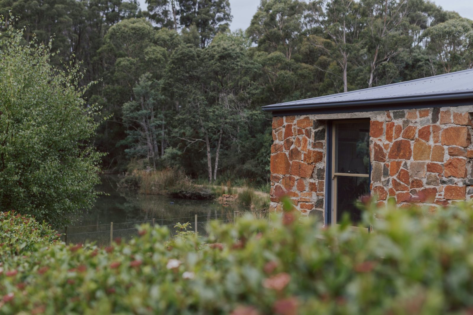 The cottage is built of stone and timber from the property and sits right on the water