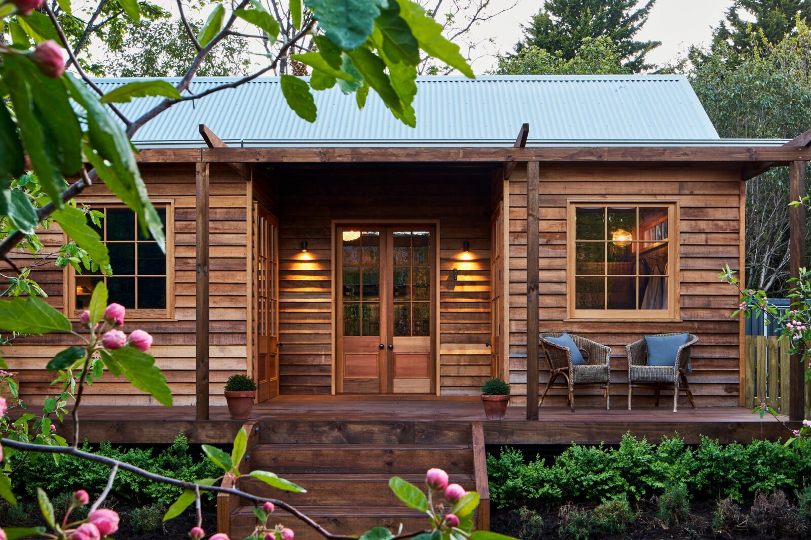 A romantic wooden cottage with retractable veranda roof and movable copper bath