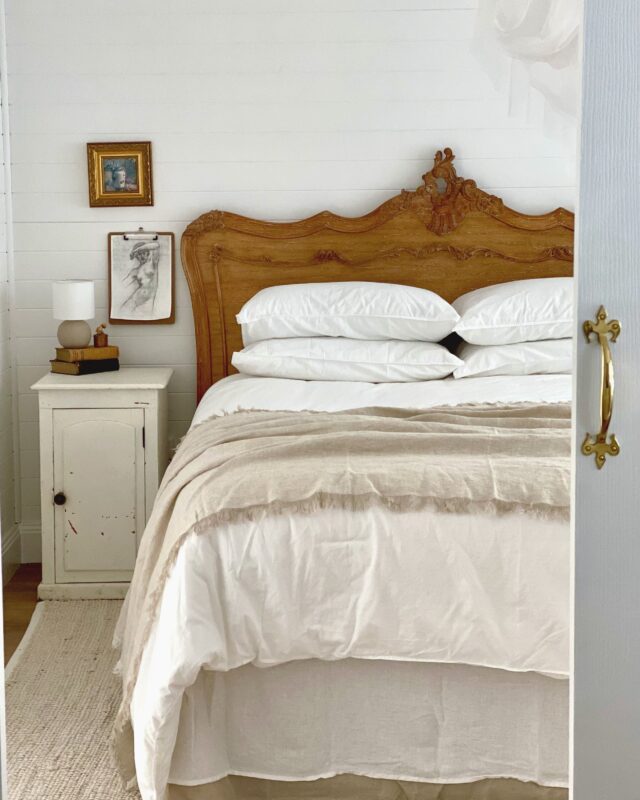 Queens size bed with bedside cabinet and small lamp