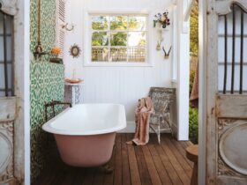bath house in the garden with a glass ceiling and a vintage style clawfoot bath tub.