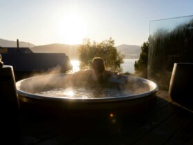 Photo of a person in a hot tub with a view over the bay