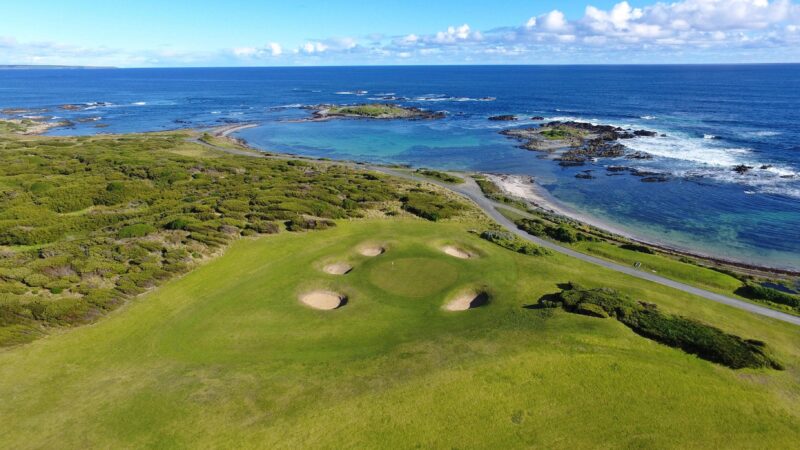 This is a photo of the third green on the King Island Course. The green is by the sea.