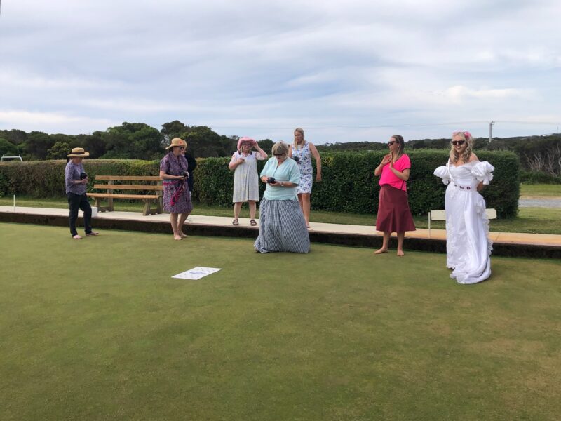 A photo of bowlers playing while wearing costumes