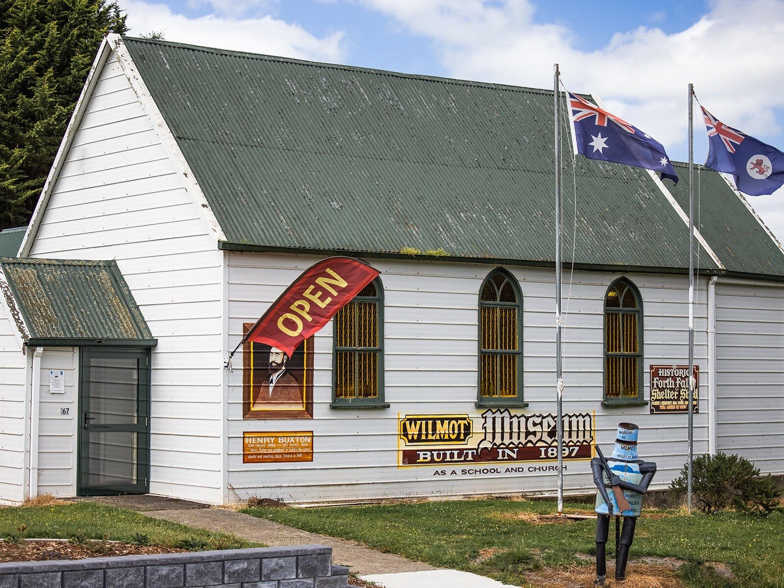 Historic building with flags and a Ned Kelly Letterbox