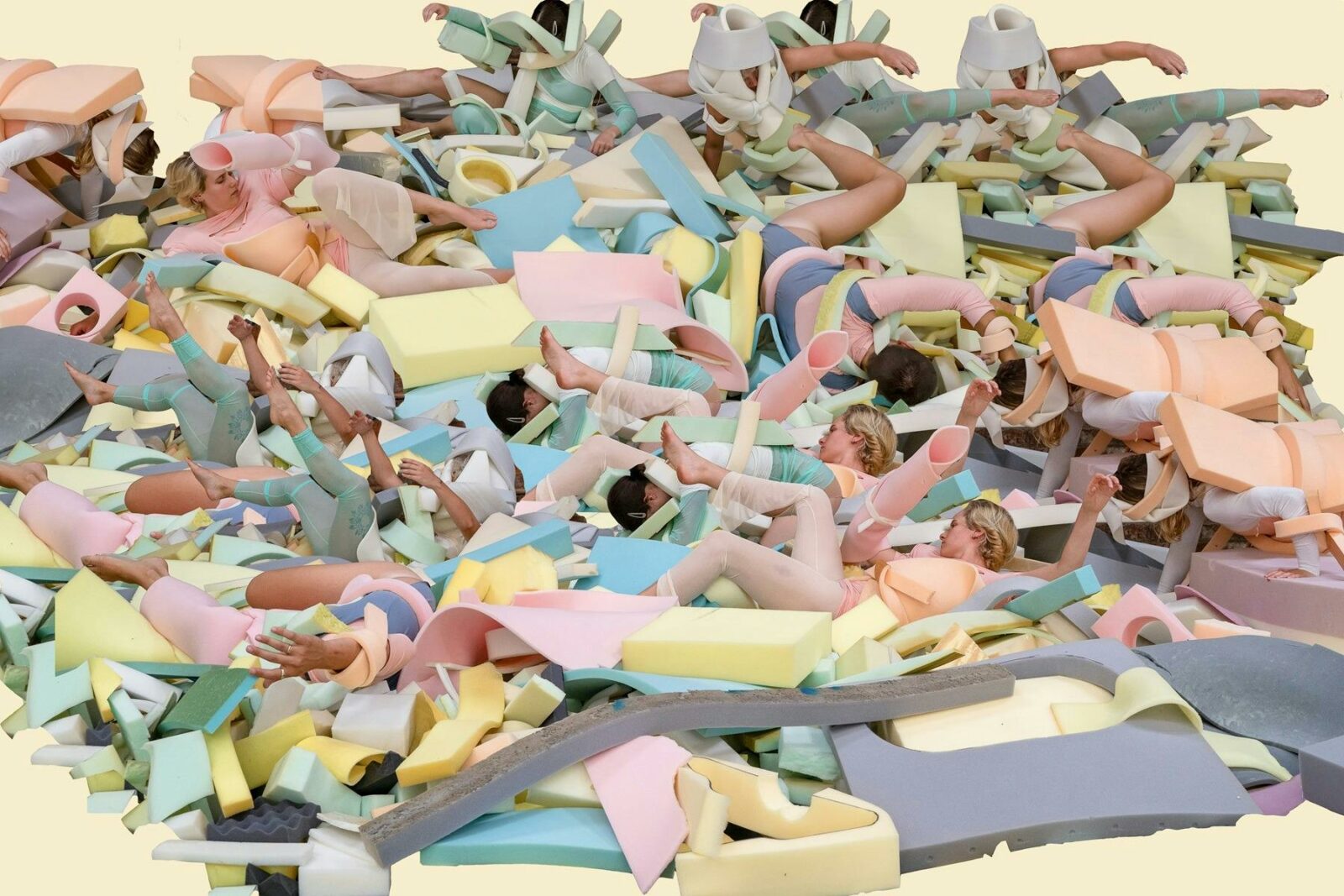 Bodies a strewn amongst colouful foam shapes, a messy landscape of sorts