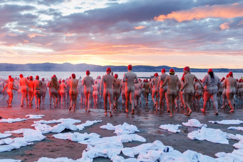 Thousands of people run into the River Derwent at sunrise for Dark Mofo's annual Nude Solstice Swim